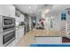 Modern kitchen showcasing stainless steel appliances, granite countertops, white cabinetry, and a kitchen island at 2934 Oceans Trce, Daytona Beach Shores, FL 32118