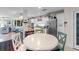 Open concept kitchen featuring white cabinetry, stainless steel appliances, and adjacent breakfast nook with seating at 2934 Oceans Trce, Daytona Beach Shores, FL 32118