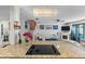 Open-concept living room with modern decor, white sofa, fireplace, and staircase leading to the upper level at 2934 Oceans Trce, Daytona Beach Shores, FL 32118