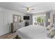 Bright main bedroom features a large window, ceiling fan, and neutral decor at 2934 Oceans Trce, Daytona Beach Shores, FL 32118