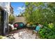Relaxing outdoor patio featuring tile floors, seating area, and lush tropical landscaping at 2934 Oceans Trce, Daytona Beach Shores, FL 32118