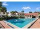 Community pool surrounded by lush landscaping and lounge chairs for a relaxing experience at 2934 Oceans Trce, Daytona Beach Shores, FL 32118