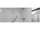 Bathroom with a glass-enclosed shower, white tile and safety grab bar at 2934 Oceans Trce, Daytona Beach Shores, FL 32118