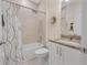 Well-lit bathroom featuring a shower-tub combo with elegant shower curtain at 3029 Adrian Dr, Ormond Beach, FL 32174