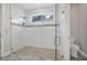 Bathroom featuring a glass enclosed shower, tile details, and bright natural light at 3029 Adrian Dr, Ormond Beach, FL 32174