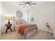 Bright bedroom with a patterned bedspread, ceiling fan and a large window at 3029 Adrian Dr, Ormond Beach, FL 32174