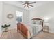 Bright bedroom with a patterned bedspread, ceiling fan and a large window at 3029 Adrian Dr, Ormond Beach, FL 32174