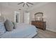 Bedroom featuring tray ceilings, a ceiling fan, and wood floors, with ample storage at 3029 Adrian Dr, Ormond Beach, FL 32174