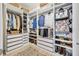 Spacious walk-in closet with custom shelving, drawers, and ample storage space for clothing and accessories at 3029 Adrian Dr, Ormond Beach, FL 32174