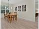 Dining room with wood table and chairs set, with a large window and decorative art at 3029 Adrian Dr, Ormond Beach, FL 32174