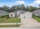 Beautiful home featuring a three-car garage, manicured lawn, and bright exterior paint at 3029 Adrian Dr, Ormond Beach, FL 32174