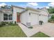 Welcoming home exterior features an orange front door, manicured lawn, and two-car garage at 3029 Adrian Dr, Ormond Beach, FL 32174