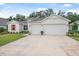 Charming single-story home featuring a three-car garage, manicured lawn, and bright exterior paint at 3029 Adrian Dr, Ormond Beach, FL 32174