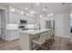 Bright kitchen features white cabinetry, stainless steel appliances, and a large island with bar seating at 3029 Adrian Dr, Ormond Beach, FL 32174