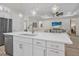 Bright kitchen featuring an island with quartz countertops, stainless appliances, and a view of the living room at 3029 Adrian Dr, Ormond Beach, FL 32174