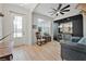 Well-lit living room with hardwood floors, custom bar, and a rocking chair at 3029 Adrian Dr, Ormond Beach, FL 32174
