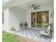 Covered patio featuring a ceiling fan, sliding glass doors, and an outdoor seating area at 3029 Adrian Dr, Ormond Beach, FL 32174
