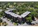 Stunning aerial view of the condo complex featuring a pool and convenient parking area at 640 N Nova Rd # 117, Ormond Beach, FL 32174