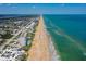 Stunning aerial view of beachfront condos along the coast, showcasing beautiful turquoise water and sandy shores at 640 N Nova Rd # 117, Ormond Beach, FL 32174