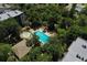 Aerial view of a community pool surrounded by lush greenery and residences at 640 N Nova Rd # 117, Ormond Beach, FL 32174
