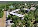 Lovely aerial view showing the condo, surrounding greenery, nearby lake, and convenient parking at 640 N Nova Rd # 117, Ormond Beach, FL 32174