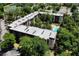 Aerial view of the condominium featuring a pool, landscaping, and multiple roof top air conditioning units at 640 N Nova Rd # 117, Ormond Beach, FL 32174