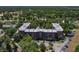 Scenic aerial view of complex with parking and tree coverage, offering a tranquil living environment at 640 N Nova Rd # 117, Ormond Beach, FL 32174