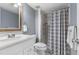 Bathroom featuring modern sink and vanity, wood-trimmed mirror, and a shower with a patterned gray and white curtain at 640 N Nova Rd # 117, Ormond Beach, FL 32174