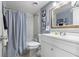 Bathroom featuring a tub and shower with curtain, a white vanity, and a wood-trimmed mirror at 640 N Nova Rd # 117, Ormond Beach, FL 32174