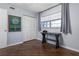 Bedroom featuring a desk, a closet, hardwood floors, and a large window at 640 N Nova Rd # 117, Ormond Beach, FL 32174