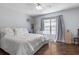 Comfortable bedroom featuring a ceiling fan, decorative lamps, and a bright window at 640 N Nova Rd # 117, Ormond Beach, FL 32174