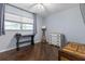 Bedroom featuring light gray walls, wood floors, a ceiling fan, and an assortment of furniture at 640 N Nova Rd # 117, Ormond Beach, FL 32174