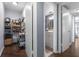Hallway featuring a view into a bathroom and into a storage closet at 640 N Nova Rd # 117, Ormond Beach, FL 32174
