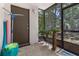 Screened in lanai featuring a dark brown door and view of the outdoors at 640 N Nova Rd # 117, Ormond Beach, FL 32174