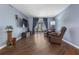 Living room features hard surface floors, neutral paint, recliners, and natural light at 640 N Nova Rd # 117, Ormond Beach, FL 32174