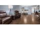 Living room features hard surface floors, neutral paint, recliners, and table with bench seating at 640 N Nova Rd # 117, Ormond Beach, FL 32174