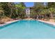 Inviting community pool with crystal-clear water, surrounded by lush landscaping and lounge chairs at 640 N Nova Rd # 117, Ormond Beach, FL 32174