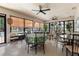 Enclosed sunroom with multiple tables, chairs, ceiling fans, and lots of windows to let in natural light at 640 N Nova Rd # 117, Ormond Beach, FL 32174