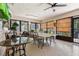 Enclosed sunroom with multiple tables, chairs, ceiling fans, and lots of windows to let in natural light at 640 N Nova Rd # 117, Ormond Beach, FL 32174