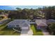 Aerial view of a single-story home with an attached garage, lush landscaping, and fenced-in backyard at 807 Scrub Oak St, South Daytona, FL 32119
