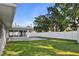 Well-maintained backyard with a white fence, patio, and views of mature trees offering privacy at 807 Scrub Oak St, South Daytona, FL 32119