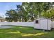 Fenced backyard features a lush lawn, storage shed, and concrete patio perfect for entertaining at 807 Scrub Oak St, South Daytona, FL 32119