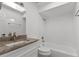 Bright bathroom featuring a vanity with stone countertops and a shower-tub combo with white tile at 807 Scrub Oak St, South Daytona, FL 32119