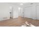 Spacious bedroom with hardwood floors, a ceiling fan, an attached closet and an open door to the ensuite bathroom at 807 Scrub Oak St, South Daytona, FL 32119