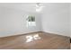 Bright bedroom has neutral walls, laminate flooring, and a ceiling fan at 807 Scrub Oak St, South Daytona, FL 32119