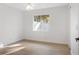 Sunlit bedroom with ceiling fan and neutral walls and flooring at 807 Scrub Oak St, South Daytona, FL 32119