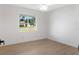 Minimalist bedroom with hardwood floors, neutral walls, and a view through the window at 807 Scrub Oak St, South Daytona, FL 32119