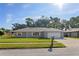 Charming home with landscaped yard, driveway, and attached two-car garage at 807 Scrub Oak St, South Daytona, FL 32119
