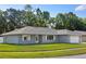 Well-maintained home with lush lawn and mature trees offers great curb appeal at 807 Scrub Oak St, South Daytona, FL 32119