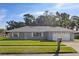 Charming single-story home with a well-manicured lawn, freshly painted exterior, and attached two-car garage at 807 Scrub Oak St, South Daytona, FL 32119